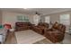 Spacious living room with multiple leather sofas, a ceiling fan, and neutral walls at 11991 104Th Ave, Seminole, FL 33778