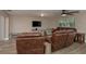 Comfortable living room featuring leather seating, a ceiling fan, and modern decor at 11991 104Th Ave, Seminole, FL 33778