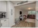 Bright living room flows from kitchen, featuring modern flooring, TV, and comfortable leather sofa with a light rug at 11991 104Th Ave, Seminole, FL 33778