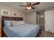 Relaxing main bedroom featuring ceiling fan, decorative pictures, and a doorway leading to the bathroom at 11991 104Th Ave, Seminole, FL 33778