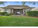 A spacious backyard features a patio, lush lawn, and well-maintained landscaping, perfect for outdoor relaxation and entertaining at 12009 Whistling Wind Dr, Riverview, FL 33569