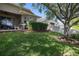 The backyard offers a patio, privacy fence, and green lawn, creating an inviting space for gatherings and outdoor activities at 12009 Whistling Wind Dr, Riverview, FL 33569