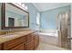Bathroom featuring a soaking tub, granite counters, and glass-enclosed shower at 12009 Whistling Wind Dr, Riverview, FL 33569