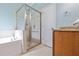 Bathroom with glass shower, large tub, and granite countertop vanity at 12009 Whistling Wind Dr, Riverview, FL 33569
