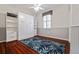 Bright bedroom featuring wood floors, a ceiling fan, and a built-in Murphy bed and storage shelves at 12009 Whistling Wind Dr, Riverview, FL 33569