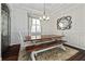 Bright dining room with a rustic wooden table and modern chandelier at 12009 Whistling Wind Dr, Riverview, FL 33569