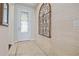 Elegant foyer showcasing decorative tile flooring, an ornate metal wall hanging and a glass paneled front door at 12009 Whistling Wind Dr, Riverview, FL 33569