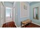 Hallway with a woven bench, leading to bathroom at 12009 Whistling Wind Dr, Riverview, FL 33569