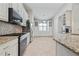 Bright and functional kitchen with stainless steel appliances, granite countertops, and a dining nook with built-in cabinets at 12009 Whistling Wind Dr, Riverview, FL 33569
