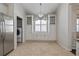 Bright kitchen area with ample storage, stainless steel appliances, and a view into the nearby laundry room at 12009 Whistling Wind Dr, Riverview, FL 33569