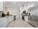 Spacious kitchen featuring stainless steel appliances, granite counters, and an open layout perfect for entertaining and cooking at 12009 Whistling Wind Dr, Riverview, FL 33569