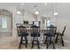Stylish kitchen showcasing a breakfast bar with seating, pendant lighting, and white cabinets with ample storage space at 12009 Whistling Wind Dr, Riverview, FL 33569