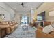 Inviting living room with wood accent wall and leather furniture at 12009 Whistling Wind Dr, Riverview, FL 33569