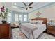 Cozy main bedroom with a decorative rug and large bed at 12009 Whistling Wind Dr, Riverview, FL 33569