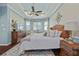 Main bedroom featuring a tray ceiling, ceiling fan, and a large bed at 12009 Whistling Wind Dr, Riverview, FL 33569