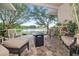 Cozy patio with a view of the pond, including comfortable seating and a fire pit table at 12009 Whistling Wind Dr, Riverview, FL 33569
