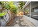 Backyard showing a patio, stone pathway, some landscaping and surrounding foliage at 12780 N 57Th St, Tampa, FL 33617