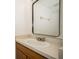 Cozy bathroom featuring a standard sink, countertop, and mirror in a well-lit space at 12780 N 57Th St, Tampa, FL 33617