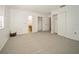 Spacious bedroom featuring neutral carpeting, ensuite bath, and walk-in closets at 12780 N 57Th St, Tampa, FL 33617