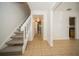 Inviting entryway featuring neutral tile flooring, stairway to the second level and open hallway leading to the back at 12780 N 57Th St, Tampa, FL 33617