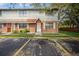 Exterior view of townhome featuring brick and siding, white trimmed windows and doorway with parking available at 12780 N 57Th St, Tampa, FL 33617