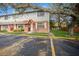 Exterior view of townhome featuring brick and siding, white trimmed windows and doorway with grassy lawn at 12780 N 57Th St, Tampa, FL 33617