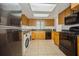 Bright kitchen with appliances, wooden cabinets, tile flooring and lots of counter space at 12780 N 57Th St, Tampa, FL 33617