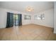 Bright living room with tile flooring, large windows, ceiling fan, and sliding glass doors at 12780 N 57Th St, Tampa, FL 33617