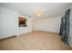 Open living area with tile floors, white walls, and access to other parts of the house at 12780 N 57Th St, Tampa, FL 33617