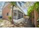 Spacious screened lanai with a brick accent wall and stone pathway in this home's rear exterior at 12780 N 57Th St, Tampa, FL 33617