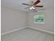 The bedroom has a tile floor, ceiling fan, and window with natural light at 13125 Wilcox Rd # 16202, Largo, FL 33774