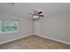 Bedroom featuring a ceiling fan, tile flooring, and natural light from the window at 13125 Wilcox Rd # 16202, Largo, FL 33774