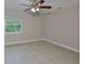 This bedroom has a tile floor, ceiling fan, and window with natural light at 13125 Wilcox Rd # 16202, Largo, FL 33774