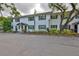 Building exterior featuring dark shutters, and mature landscaping at 13125 Wilcox Rd # 16202, Largo, FL 33774
