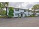 Inviting two-story condo with well maintained landscaping, fresh white paint, and black shutters at 13125 Wilcox Rd # 16202, Largo, FL 33774