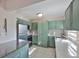 Well-lit kitchen with stainless steel appliances, light countertops, and vintage green cabinetry at 13125 Wilcox Rd # 16202, Largo, FL 33774