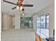 Open concept living space leading to kitchen and screened porch with tile flooring at 13125 Wilcox Rd # 16202, Largo, FL 33774
