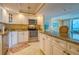 Bright kitchen with stainless steel appliances and an island featuring granite countertops at 14146 Gulf Blvd # 4B, Madeira Beach, FL 33708