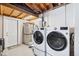 Basement laundry room with modern washer, dryer, storage, and access to the rest of the home at 1530 Picardy Cir, Clearwater, FL 33755