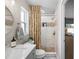 Updated bathroom with modern vanity, mosaic tile accents, glass shower, and stylish fixtures at 1530 Picardy Cir, Clearwater, FL 33755