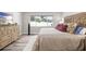 Bedroom with a patterned headboard, a dresser, and wood look floors at 1530 Picardy Cir, Clearwater, FL 33755