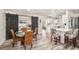Open-concept dining area with wood floors, bar seating, and access to the kitchen and living spaces at 1530 Picardy Cir, Clearwater, FL 33755