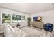 Bright living room with comfortable seating, offering a relaxing space for entertaining with a large window at 1530 Picardy Cir, Clearwater, FL 33755