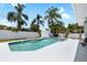 Private pool with a lounge chair surrounded by tropical plants at 1530 Picardy Cir, Clearwater, FL 33755