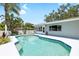 Sparkling pool with lush tropical landscaping offers a relaxing backyard oasis at 1530 Picardy Cir, Clearwater, FL 33755
