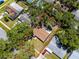 Overhead view of a property, framed by a red outline, nestled amidst trees and residential homes at 1573 Cumberland Ln, Clearwater, FL 33755