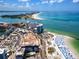 Stunning aerial view of a waterfront property with pristine sandy beaches, turquoise ocean water, and luxurious high-rise condominiums at 1573 Cumberland Ln, Clearwater, FL 33755