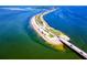 Breathtaking aerial view of a coastal highway stretching across the turquoise waters of a Florida beach community at 1573 Cumberland Ln, Clearwater, FL 33755