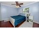 A light and airy bedroom with wooden floors and a ceiling fan at 1573 Cumberland Ln, Clearwater, FL 33755