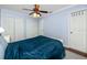 Cozy bedroom with blue walls, ceiling fan and ample closet space at 1573 Cumberland Ln, Clearwater, FL 33755